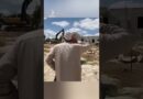 Palestinian man recites call to prayer in front of Israeli bulldozers