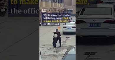 Chinese police officer pulls boy away from oncoming motorcycle #shorts