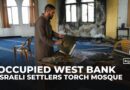 Israeli settlers torch and deface a mosque in a Palestinian village in the occupied West bank