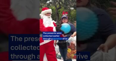 Santa Claus sweeps down from bridge to deliver gifts in Guatemala