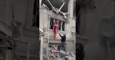 A child and his father pulled from the rubble after US-Israeli strikes