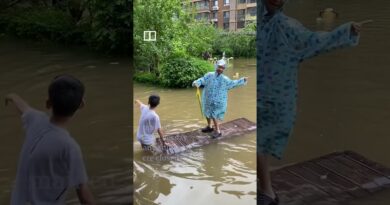 Residents ride floodwaters in northern China